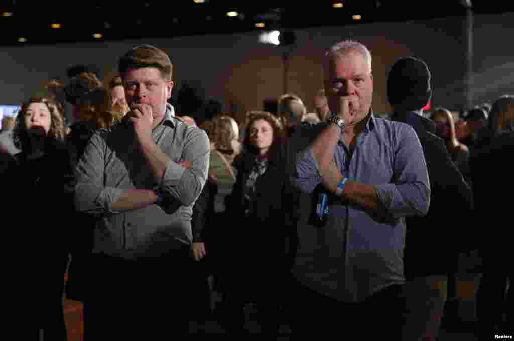 Supporters of Democratic presidential candidate, former Vice President Joe Biden, watch televised results at his rally in Des Moines, Iowa, Feb. 3, 2020.