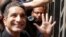 Egyptian television satirist Bassem Youssef waves to his supporters as he enters Egypt's state prosecutors office to face charges for allegedly insulting Islam and the country's leader, in Cairo, Mar. 31, 2013.
