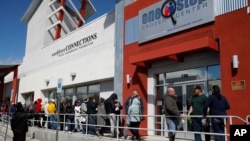 People wait in line for help with unemployment benefits at the One-Stop Career Center in Las Vegas, March 17, 2020. 