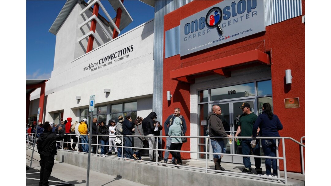 People wait in line for help with unemployment benefits at the One-Stop Career Center in Las Vegas, March 17, 2020.