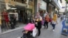 Women walk past open shops, as Lebanon is gradually reopening its economy following a four-day shutdown imposed to curb the spread of coronavirus disease (COVID-19) in Hamra street in Beirut, May 18, 2020.