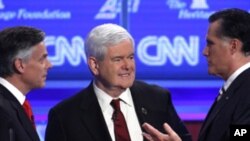 (From left) Republican presidential candidates former Utah Gov. Jon Huntsman, former house speaker Newt Gingrich and former Massachusetts governor Mitt Romney at a Republican presidential debate in Washington, Tuesday, Nov. 22, 2011.