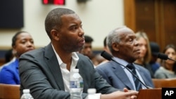Author Ta-Nehisi Coates, left, and actor Danny Glover, right, testify about reparation for the descendants of slaves during a hearing before the House Judiciary Subcommittee on the Constitution, Civil Rights and Civil Liberties, Washington, June 19, 2019.