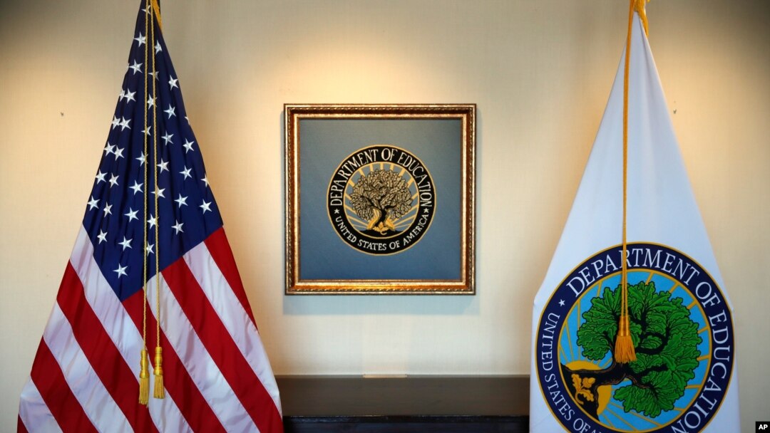 FILE - In this Aug. 9, 2017, photo, flags decorate a space outside the office of the Education Secretary at the Education Department in Washington.