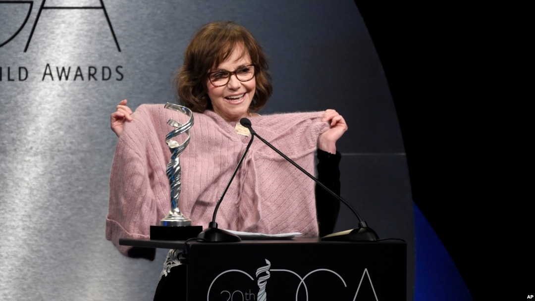 Sally Field holds up a sweater worn by her character in "Forrest Gump" as she presents the career achievement award at the 20th annual Costume Designers Guild Awards at The Beverly Hilton hotel on Tuesday, Feb. 20, 2018, in Beverly Hills, California. 
