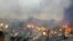 Les ruines en feu du marché de Bouaké le  27 août 2019 suite à un incendie dans la nuit (Photo par - / AFP)