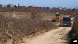 Vin McAloon drives his taxi down a road in New Shoreham, R.I. The town's taxi rules include a surcharge for driving on dirt roads, April 11, 2017. 