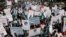 FILE - Employees of Pakistan's biggest television station Geo TV attend a protest against the Pakistan Electronic Media Regulatory Authority after the station's license was suspended, in Karachi, May 22, 2014.