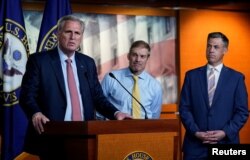 House Minority Leader Kevin McCarthy, R-Calif., announces the withdrawal of his nominees to serve on a special committee probing the Jan. 6 attack on the Capitol, July 21, 2021, as Reps. Jim Jordan of Ohio, center, and Jim Banks of Indiana stand by.