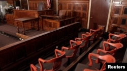 FILE -- A view of the jury box (front), where jurors would sit in and look towards the judge's chair (C), the witness stand (R) at the New York Supreme Court.