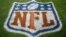 FILE - An NFL logo is displayed on the field before an NFL football game between the New England Patriots and the Denver Broncos in Denver, Nov. 12, 2017. Fox and the NFL have agreed to a five-year deal for Thursday night football games, Fox announced Wednesday.