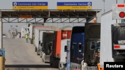 Trucks wait in a long queue for border customs control to cross into the U.S. at the Otay border crossing in Tijuana, Mexico, Feb. 2, 2017.