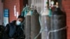 FILE - A COVID-19 patient receives oxygen outside an emergency ward at a government-run hospital in Kathmandu, Nepal, May 13, 2021. 