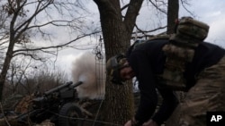 Ukrainian serviceman fire toward Russian positions in Kharkiv region, Ukraine, March 12, 2025. 