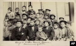 FILE - This photo made available by the Presbyterian Historical Society, Philadelphia, shows students at a Presbyterian boarding school in Sitka, Alaska, in the summer of 1883.