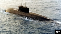 FILE - A Russian-built, Kilo-class diesel submarine purchased by Iran, is towed by a support vessel in this photograph taken in the central Mediterranean Sea during the week of Dec. 23, 1995. (DOD/AFP)
