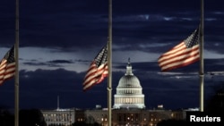 With the U.S. Capitol in the distance, flags fly at half-staff at the Washington Monument on the National Mall following the death of former U.S. President Jimmy Carter, in Washington, Dec. 30, 2024. 