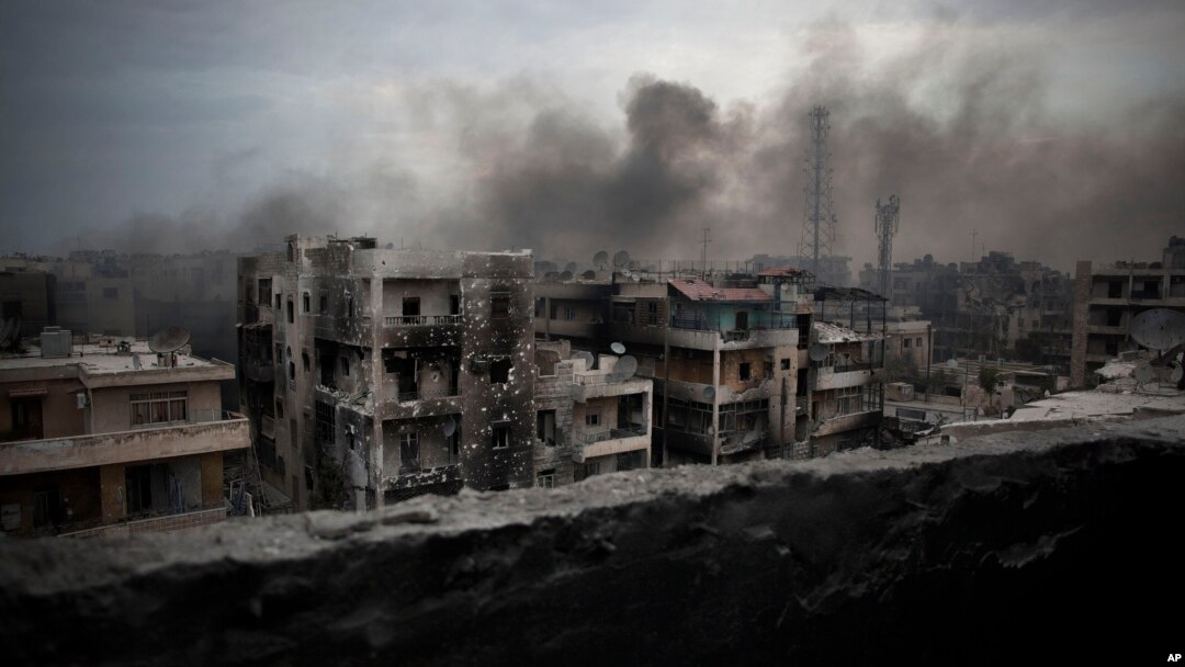 FILE - Smoke rises over Saif Al Dawla district, in Aleppo, Syria, Oct. 2, 2012. 
