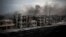FILE - Smoke rises over Saif Al Dawla district, in Aleppo, Syria, Oct. 2, 2012. 
