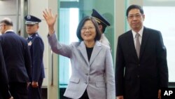 FILE - Taiwanese President Tsai Ing-wen waves to the media as she departs for Latin America at Taoyuan International Airport in Taoyuan, Taiwan, Aug. 12, 2018. 