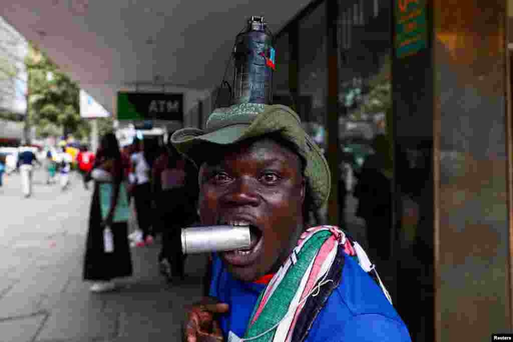 A man has a grenade attached to his head as activists and civil society members participate in a nationwide march titled &quot;End Femicide Kenya&quot; to raise awareness about gender-based violence (GBV) in downtown Nairobi. REUTERS/Thomas Mukoya