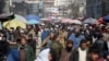 Afghans walk through a crowded market in Kabul, Afghanistan, Feb. 22, 2020.