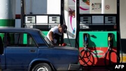 (FILES) A man fills a tank at a gas station in Havana, on October 2, 2023.