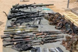 FILE - Arms and ammunitions recovered from Boko Haram militants are displayed in Goniri, Yobe State, in Nigeria's restive northeast, July 3, 2019.