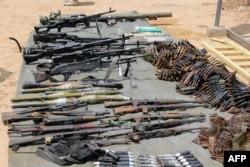 FILE - Arms and ammunitions recovered from Boko Haram militants are displayed in Goniri, Yobe State, in Nigeria's restive northeast, July 3, 2019.