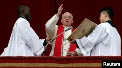 Pope Francis makes a blessing as he delivers his first "Urbi et Orbi" (to the city and world) message from the balcony overlooking St. Peter's Square at the Vatican, Dec. 25, 2013