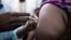 FILE - Staff members of the Teaching Hospital receive the first vaccination treatment for yellow fever in El Geneina, West Darfur in this Nov. 14, 2012 handout.  