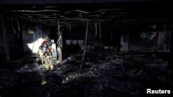 Firefighters stand at a scene of a fire, in Seongnam, South Korea, Jan. 3, 2025. 