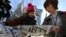 Japanese women react as they read extra newspapers in Tokyo reporting about an online video that purported to show an Islamic State group militant beheading Japanese journalist Kenji Goto, Feb. 1, 2015. 