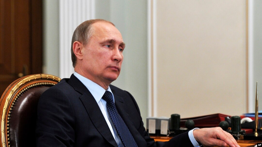 Russian President Vladimir Putin listens during a meeting in the Novo Ogaryovo residence, outside Moscow on Monday, April 13, 2015.