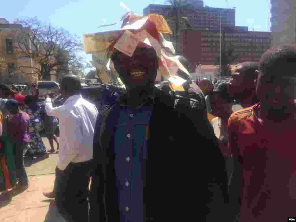 A protester with discarded bearers cheques.