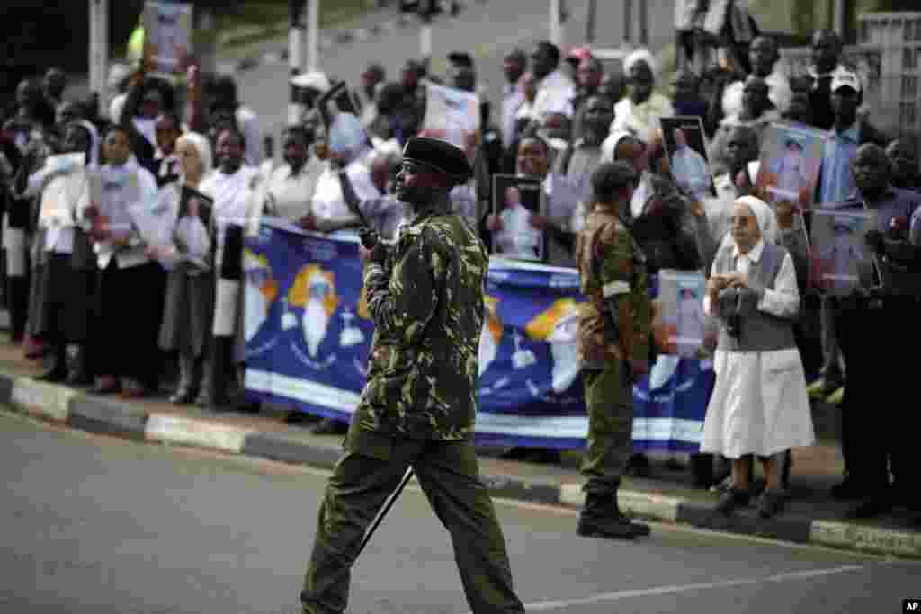 Soldiers patrol as people wait for the arrival of Pope Francis, in Nairobi&#39;s State House, Nov. 25, 2015.