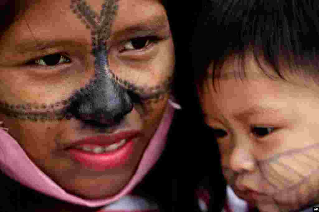 A Munduruku Indigenous woman and child from Alto Tapajos in the Brazilian state of Para attend a show of support for a government decree legalizing mining on Indigenous land outside the Supreme Court in Brasilia.