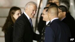 U.S. Vice President Joe Biden, second from left, shakes hands with U.S. Army Gen. Curtis Scaparrotti upon his arrival at Osan Air Base in Osan, South Korea, Dec. 5, 2013.