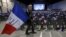 A supporter holds a French flag before a political rally of Marion Marechal-Le Pen, French National Front political party candidate for the second round of regional elections in Marseilles, Dec. 9, 2015.