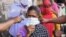 Volunteers from the Diocese of Amritsar Church of North India distribute face masks to people during a government-imposed nationwide lockdown as a preventive measure against COVID-19 in Amritsar on April 15, 2020. 