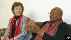 South African Archbishop and Nobel Laureate Desmond Tutu (R) speaks as former President of Ireland Mary Robinson watches during an interview in New Delhi, February 8, 2012.