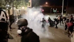 Protesters confront with the police near an Immigration and Customs Enforcement centre in Portland, Oregon, Aug. 20, 2020, in this still image from a video obtained from social media.