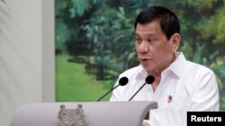 FILE - Philippine President Rodrigo Duterte delivers a speech at the start of a state dinner hosted by Singapore's President Tony Tan at the Istana in Singapore, Dec. 15, 2016.