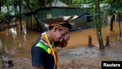 Indigenous leader Vice Cacique Sucupira of the Pataxo ethnicity reacts as he observes flooding in Nao Xoha village after pouring rains, in Sao Joaquim de Bicas, Minas Gerais state, Brazil, Jan. 12, 2022. 