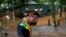 Indigenous leader Vice Cacique Sucupira of the Pataxo ethnicity reacts as he observes flooding in Nao Xoha village after pouring rains, in Sao Joaquim de Bicas, Minas Gerais state, Brazil, Jan. 12, 2022. 
