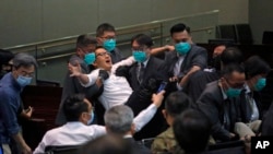 Pan-democratic legislator Lam Cheuk-ting is taken away by security during a Legislative Council's House Committee meeting in Hong Kong, May 18, 2020.
