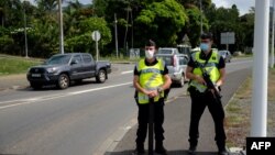 Gendarmes secure the road of Saint Michel, on the day of the vote for the referendum on independence, in Mont Dore, on the French South Pacific territory of New Caledonia on Dec. 12, 2021.