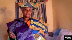 Charlotte Mapendo fled the DRC two years ago, and now supports her family by selling kitenge cloth door to door. June 24, 2014. (Hilary Heuler / VOA News)