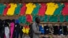FILE — A Cameroonian walks past a store selling Indomitable Lions merchandise in Yaonde.