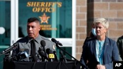 Santa Fe County Sheriff Adan Mendoza, left, speaks as District Attorney Mary Carmack-Altwies listens during a news conference in Santa Fe, New Mexico, Oct. 27, 2021. 